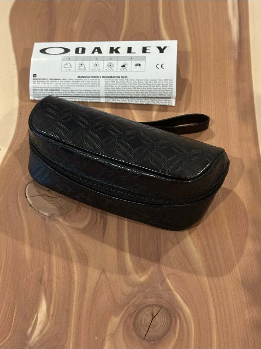 NWT Oakley Black Embossed Soft Sunglasses Case with wrist strap.